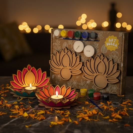 Art supplies including candles and paint set on a dark surface with blurred lights in the background