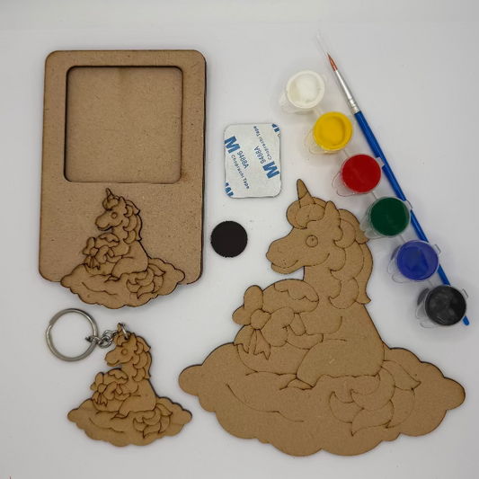 Unicorn-shaped wooden cutout with paint supplies on a white background