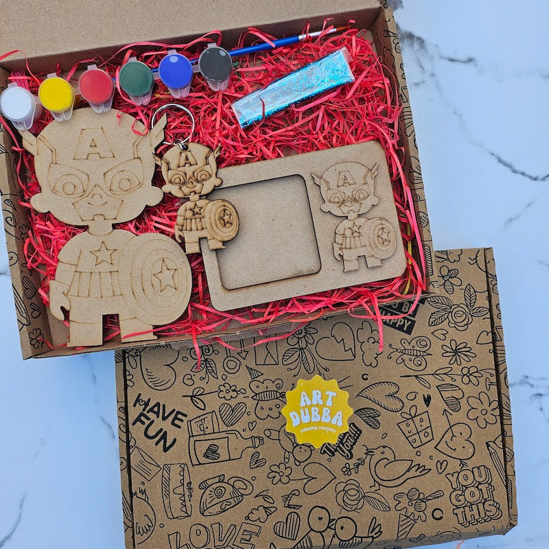 Wooden craft items in a box with decorative elements on a marble surface
