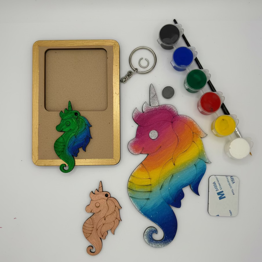 Colorful unicorn and seahorse-shaped objects with paint supplies on a white background