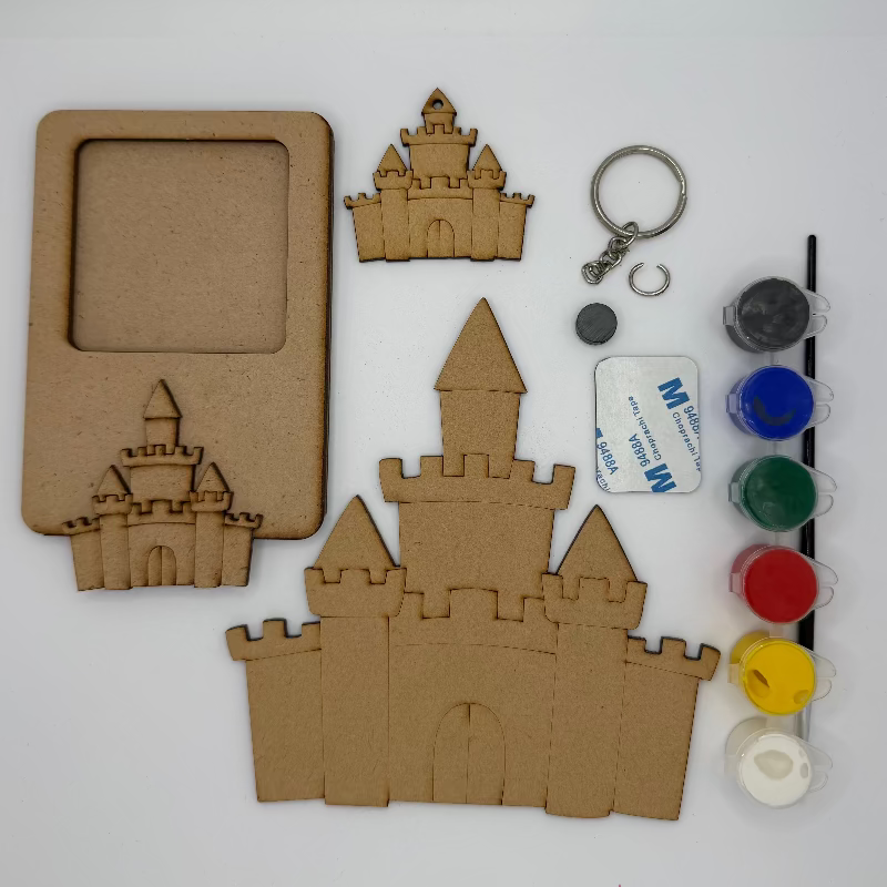 Cardboard castle kit with paint bottles and a keychain on a white background