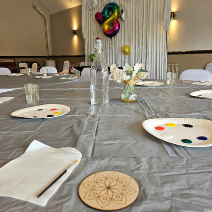 Mandala coaster with colourful elements on a 8th birthday balloon backdrop on a wall