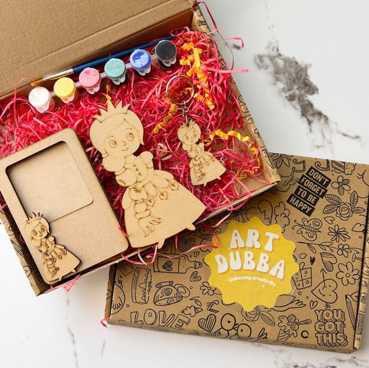 Wooden art supplies including a frame, figurines, and paint bottles in a box with 'Art Bubba' branding.