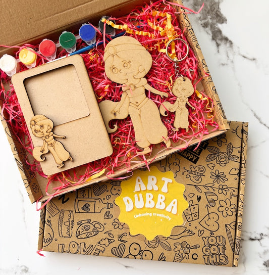 Wooden art supplies including a picture frame, figures, and paintbrushes in a 'Art Dubba' box.
