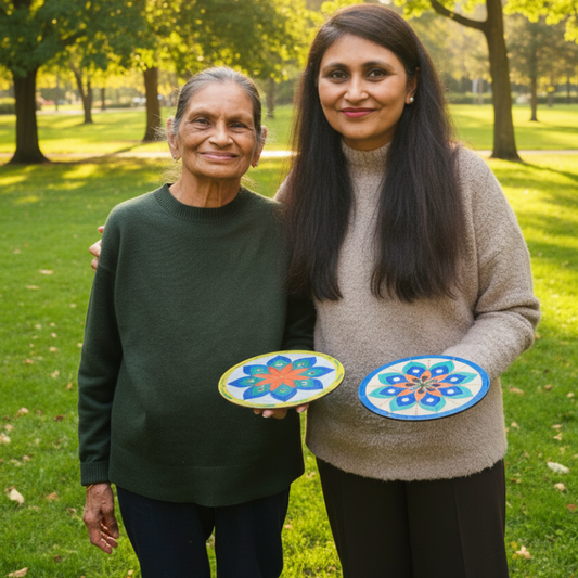 Two women holding colorful plates with floral designs in an indoor setting.