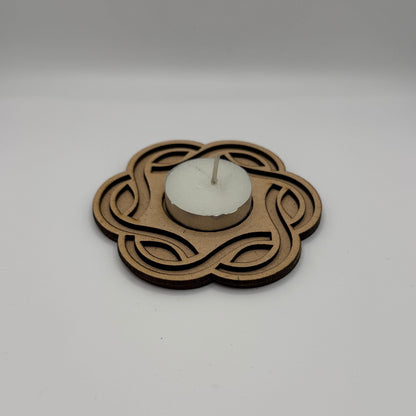 Decorative wall clock with intricate design on a plain white wall.