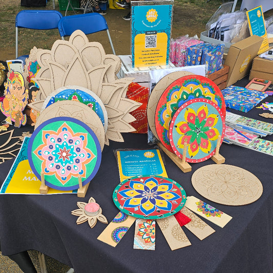 Table with decorative items and crafts at an outdoor event