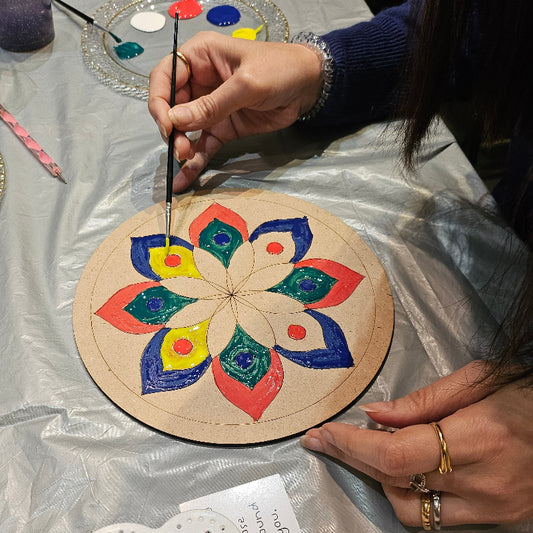 lady painting mandala with painting materials
