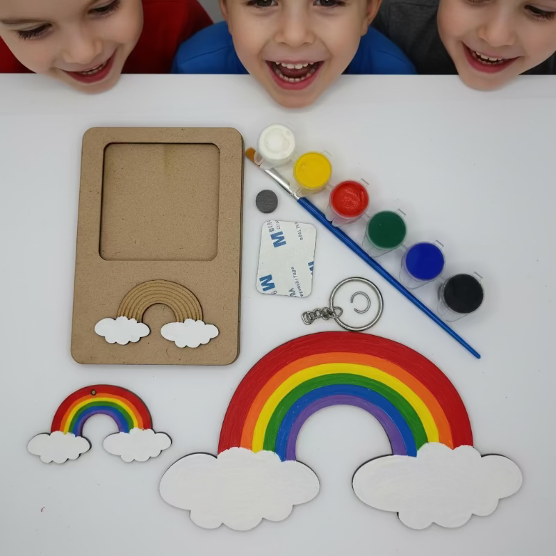 Children's craft activity with rainbow and cloud decorations on a table.