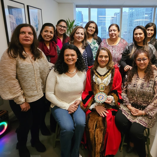 Group of people posing together in a room with colorful decorations