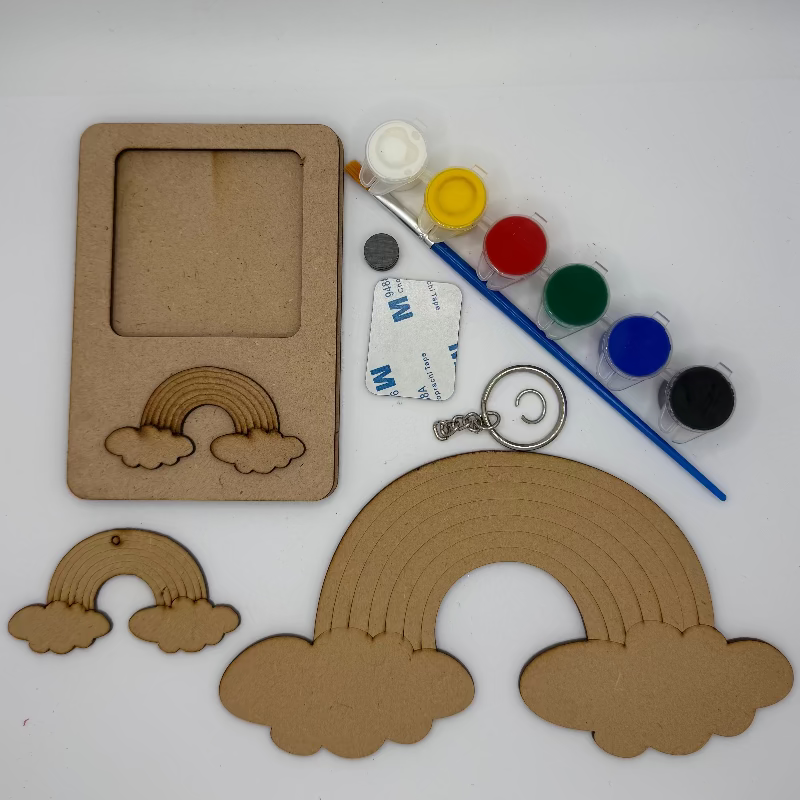 Craft materials including cardboard cutouts of rainbows and clouds, paint bottles, a brush, and a keychain on a white background.