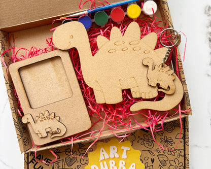 Art Dubba craft kit with wooden dinosaur shapes and supplies in a box.
