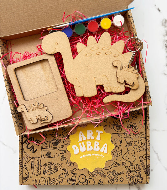 Art Dubba craft kit with wooden dinosaur shapes and supplies in a box.