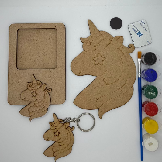 Unicorn-shaped wooden cutouts with paint supplies on a white background