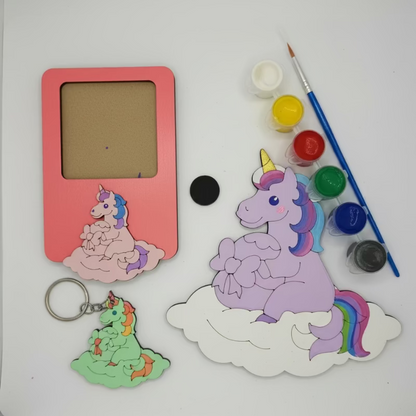 Unicorn-themed items including a pink frame, keychain, and stickers on a white background with paint supplies.