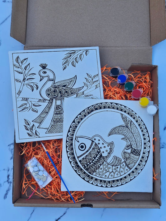 Open cardboard box with mandala art cards and decorative items on a light blue surface.