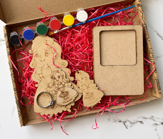 Wooden craft kit with paint, brush, and wooden figures in a cardboard box.